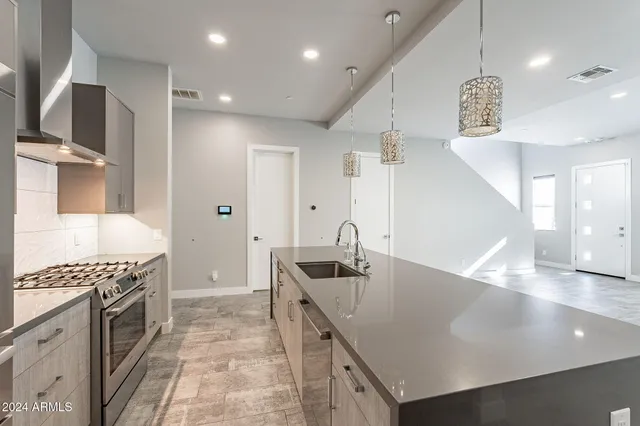 a kitchen with a sink and a refrigerator