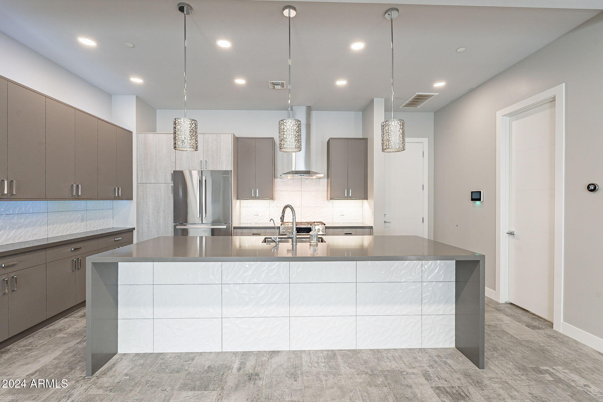 2645 East Osborn Road, Unit 3 Phoenix, AZ 85016 - Photo 14 of 31 a large white kitchen with kitchen island a sink stainless steel appliances and a counter top