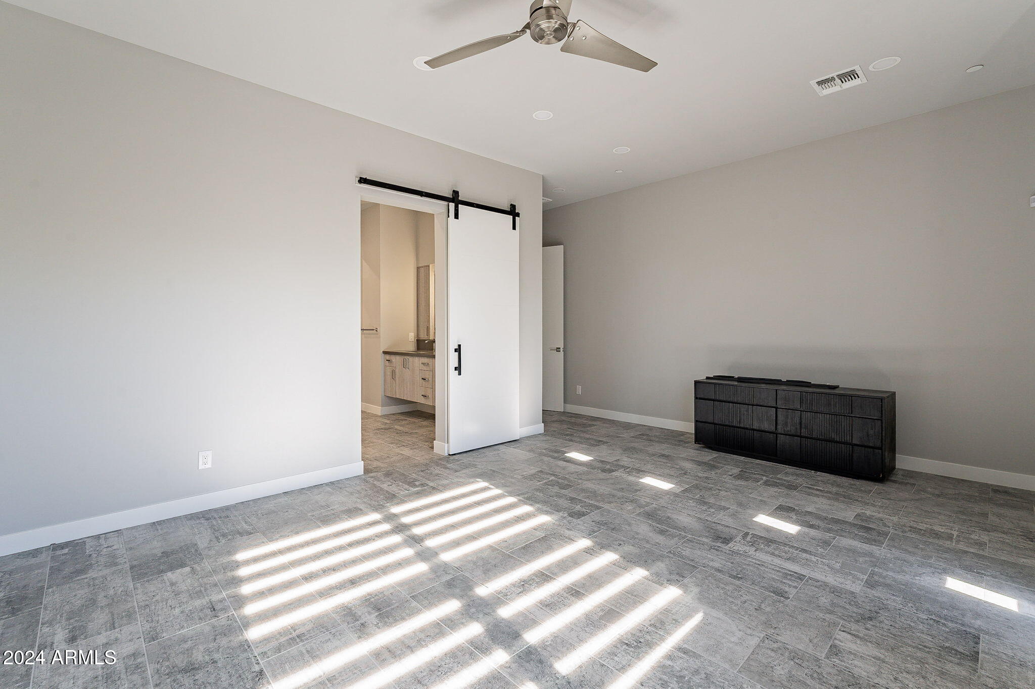 2645 East Osborn Road, Unit 3 Phoenix, AZ 85016 - Photo 17 of 31 a view of empty room with wooden floor and ceiling fan