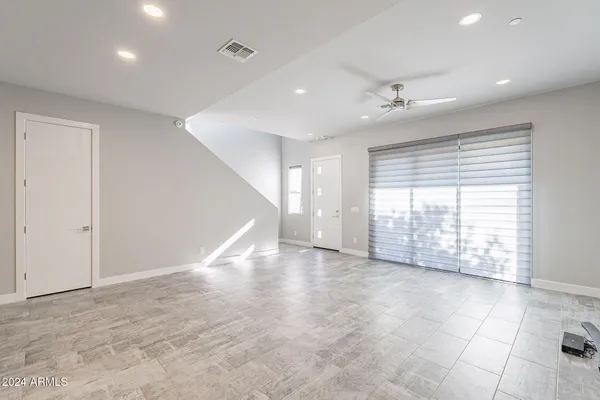 a large white kitchen with kitchen island a sink a stove a oven a dining table and chairs