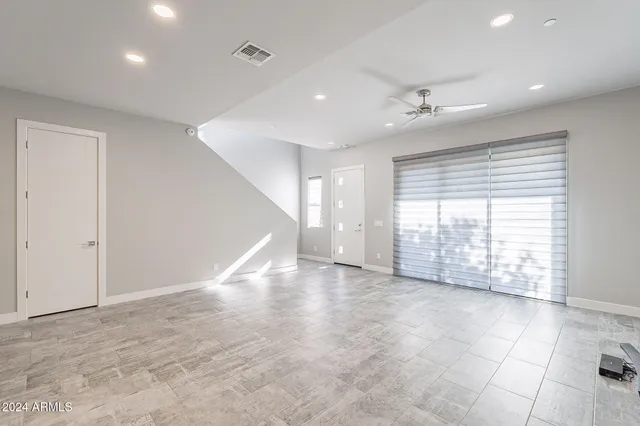 a large white kitchen with kitchen island a sink a stove a oven a dining table and chairs