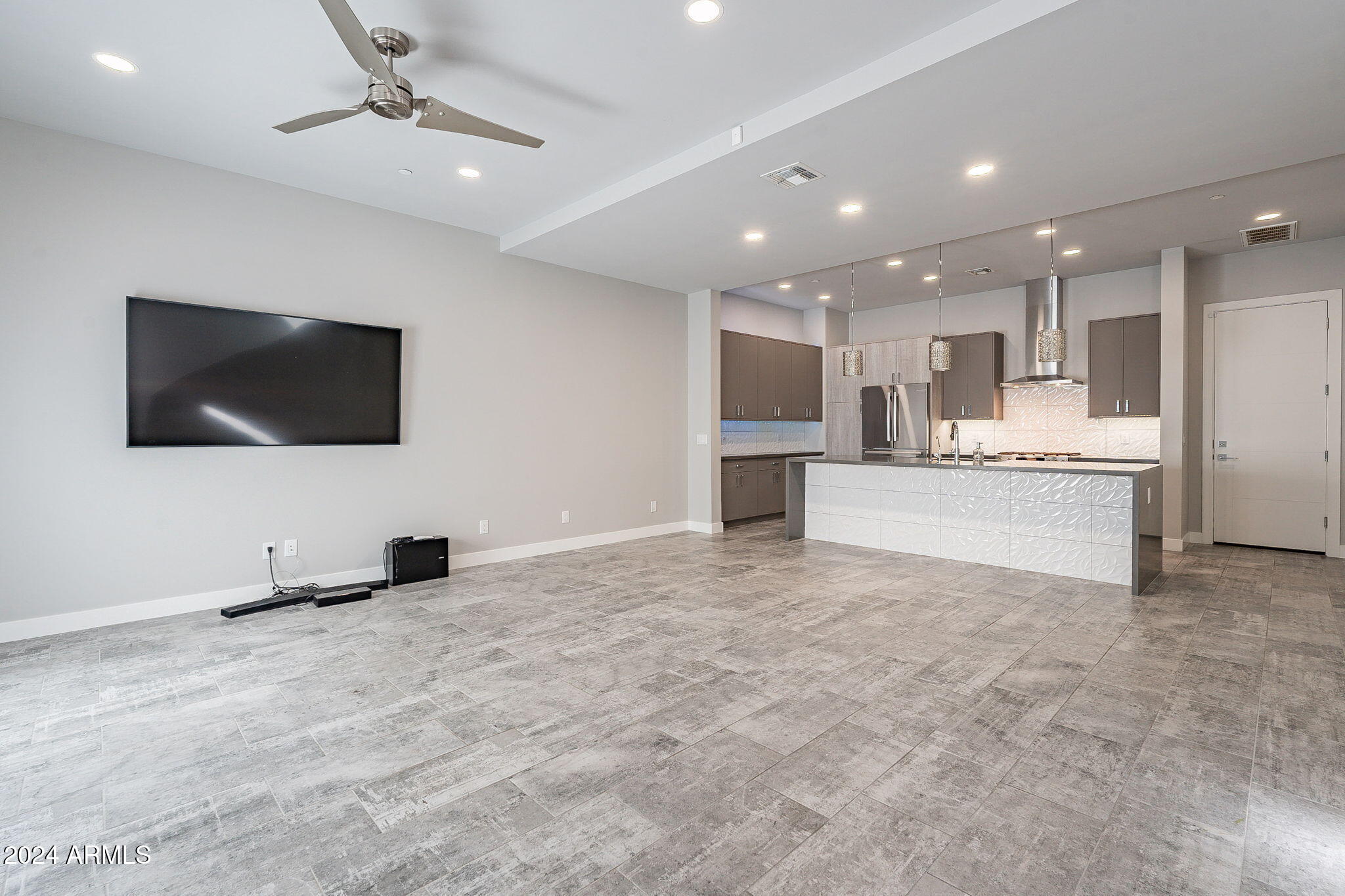 2645 East Osborn Road, Unit 3 Phoenix, AZ 85016 - Photo 7 of 31 a living room with stainless steel appliances kitchen island granite countertop a sink and a flat screen tv
