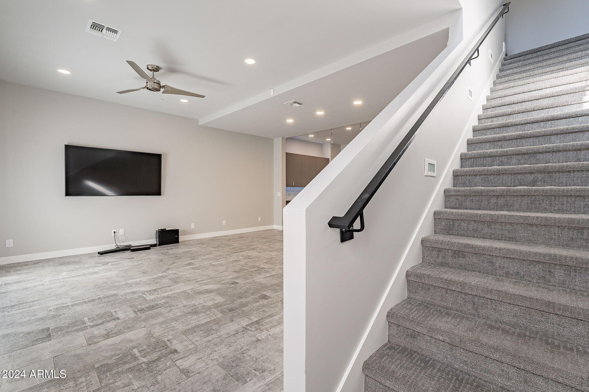 2645 East Osborn Road, Unit 3 Phoenix, AZ 85016 - Photo 8 of 31 a view of an empty room with wooden floor and stairs