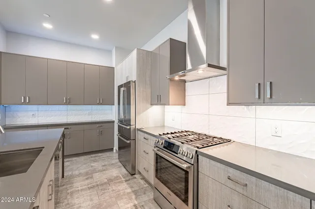 a kitchen with kitchen island a sink and a refrigerator