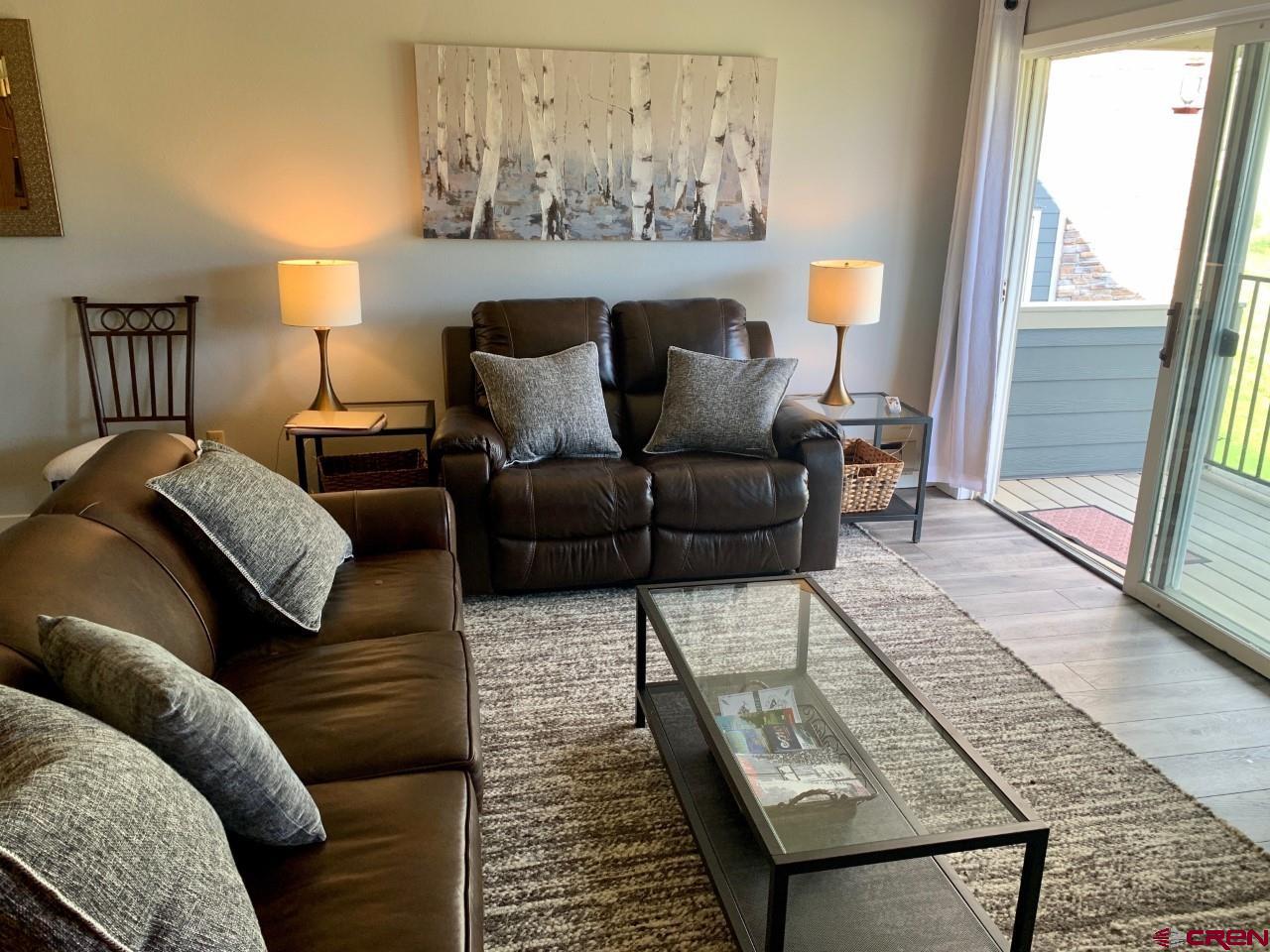 31 Crested Mountain Lane, Unit C2 Crested Butte, CO 81225 - Photo 11 of 25 a living room with furniture and a rug