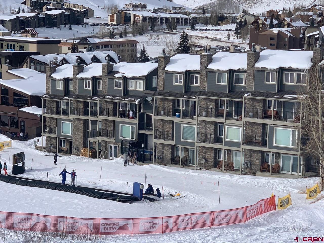 31 Crested Mountain Lane, Unit C2 Crested Butte, CO 81225 - Photo 2 of 25 a view of building with cars parked
