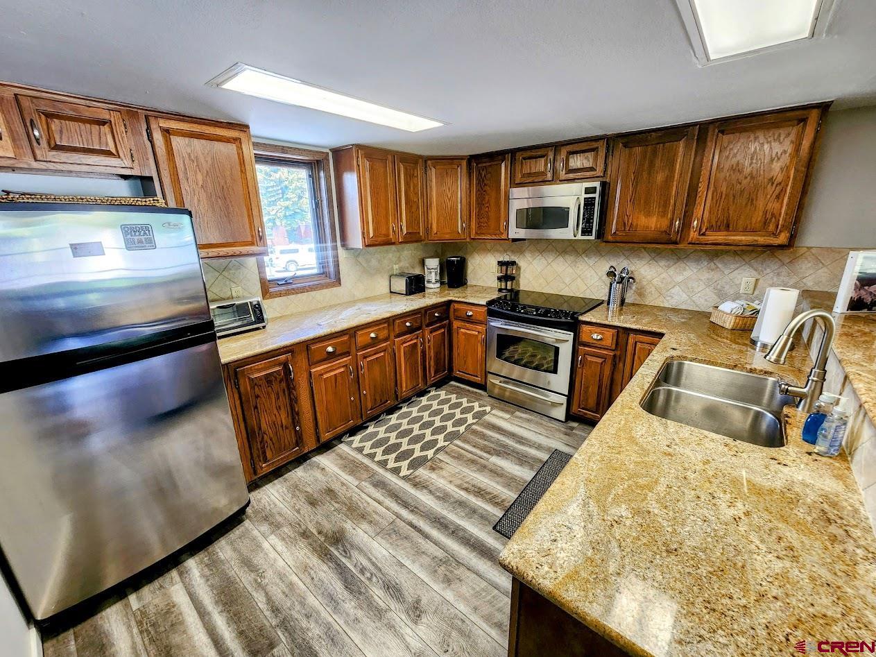 31 Crested Mountain Lane, Unit C2 Crested Butte, CO 81225 - Photo 4 of 25 a kitchen with a stove sink and cabinets