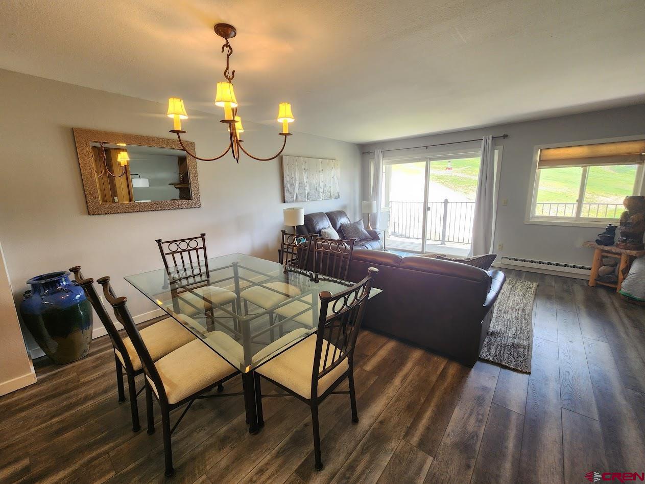 31 Crested Mountain Lane, Unit C2 Crested Butte, CO 81225 - Photo 5 of 25 a view of a dining room with furniture and wooden floor