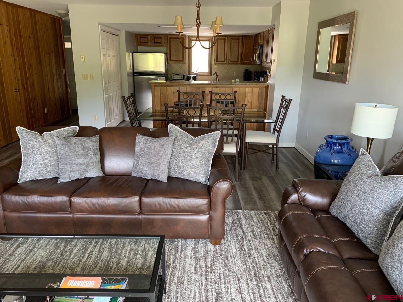 31 Crested Mountain Lane, Unit C2 Crested Butte, CO 81225 - Photo 6 of 25 a living room with furniture and a fireplace