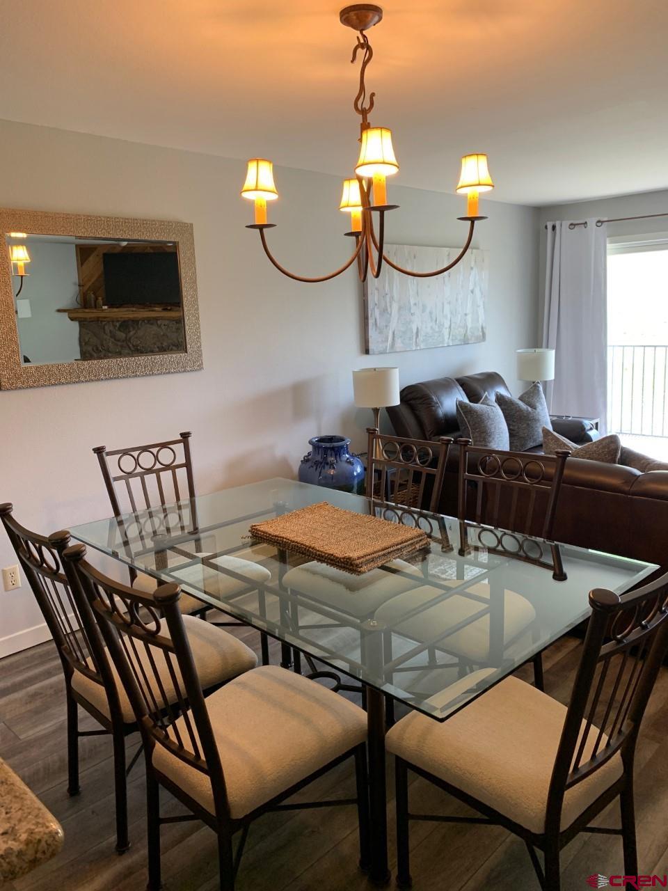31 Crested Mountain Lane, Unit C2 Crested Butte, CO 81225 - Photo 7 of 25 a kitchen with a table chairs and a kitchen