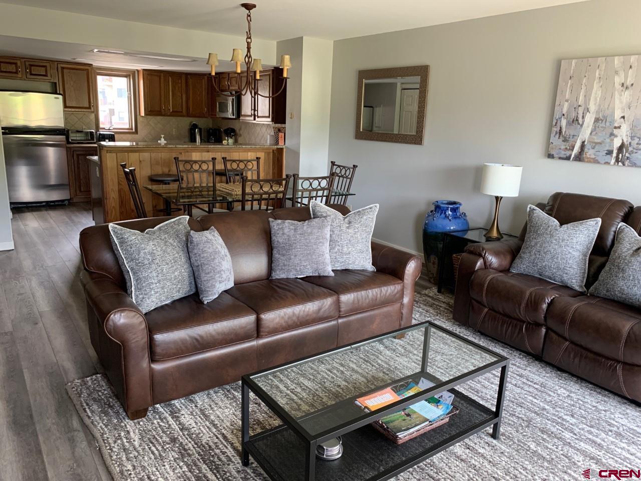 31 Crested Mountain Lane, Unit C2 Crested Butte, CO 81225 - Photo 8 of 25 a living room with furniture and a chandelier