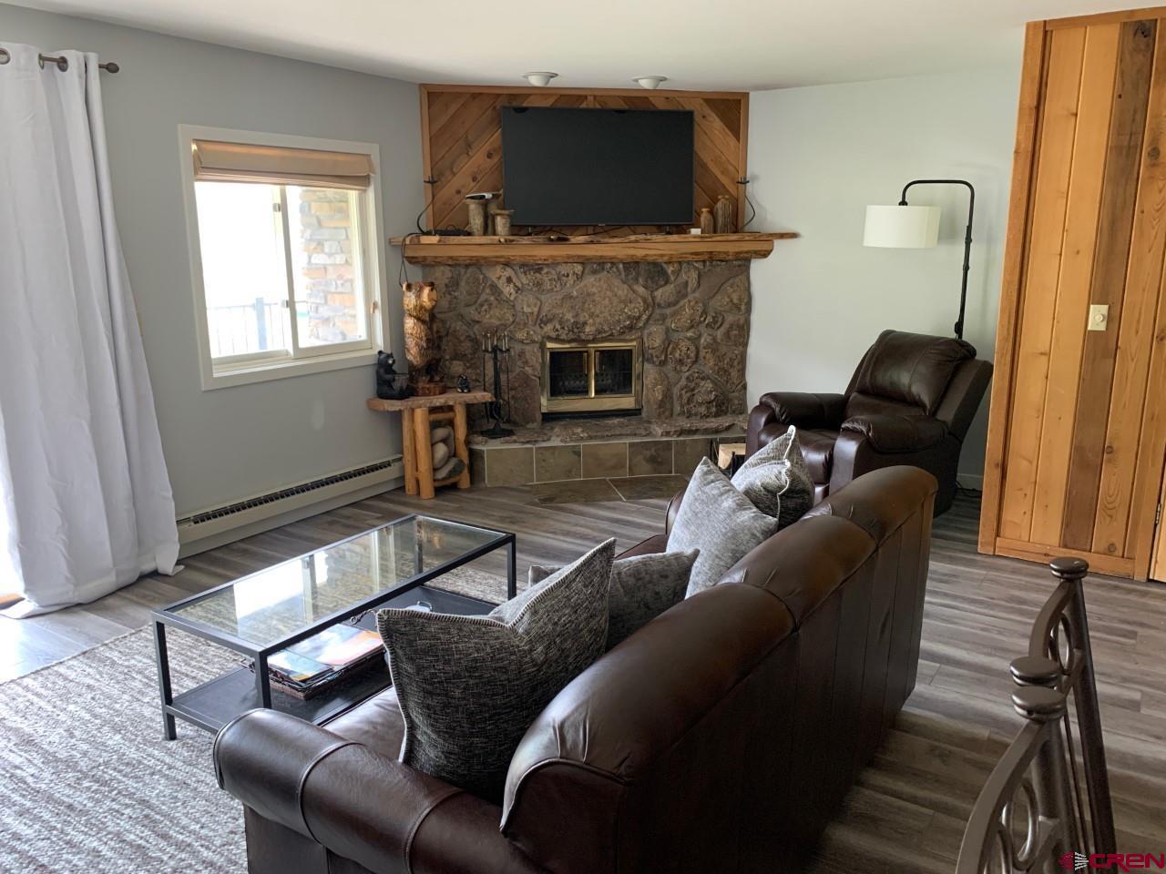 31 Crested Mountain Lane, Unit C2 Crested Butte, CO 81225 - Photo 9 of 25 a living room with furniture and a fireplace