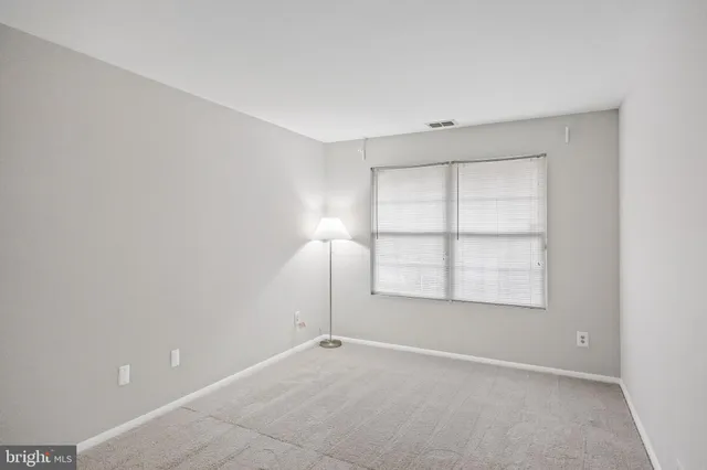 an empty room with a empty space and windows