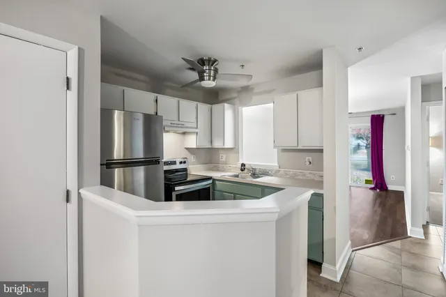 a kitchen with refrigerator and cabinets