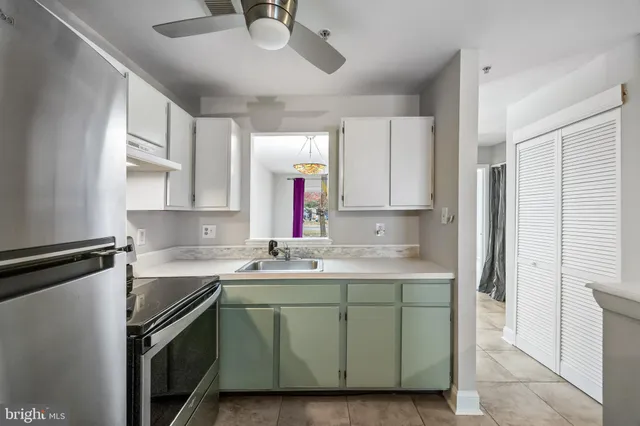 a kitchen with a sink and stainless steel appliances