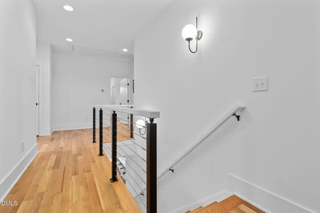 a spacious bedroom with a large bed and a rug