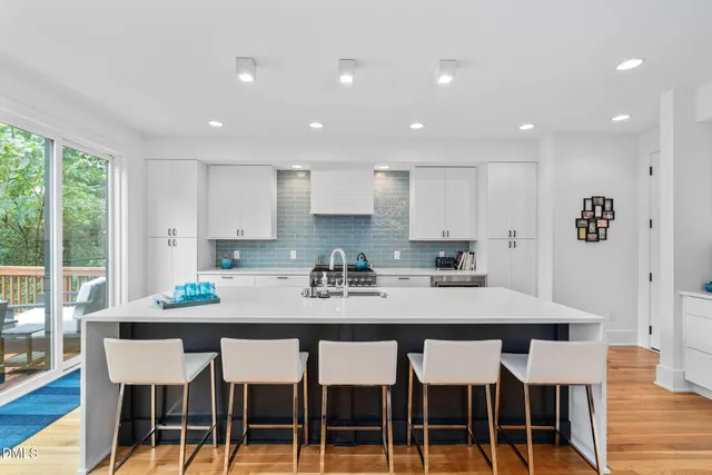 a kitchen with stainless steel appliances granite countertop a stove and a refrigerator