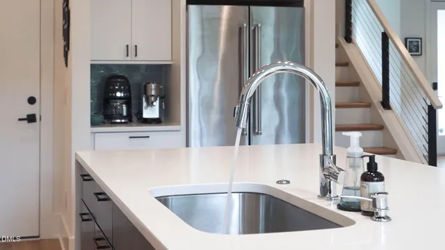 a kitchen with white cabinets and appliances
