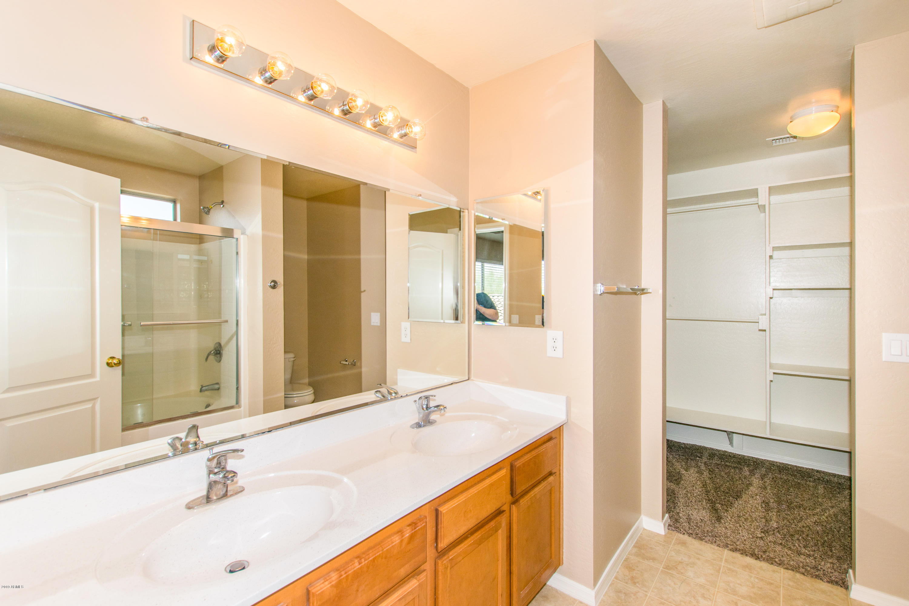 43750 West Magnolia Road Maricopa, AZ 85138 - Photo 15 of 28 a bathroom with a sink and a mirror