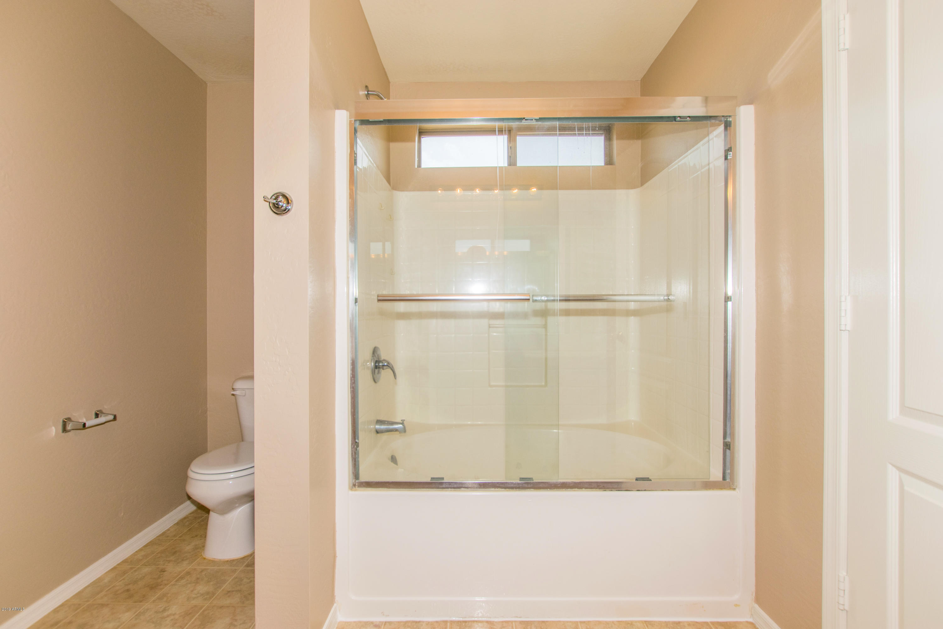 43750 West Magnolia Road Maricopa, AZ 85138 - Photo 16 of 28 a bathroom with a granite countertop shower and a toilet