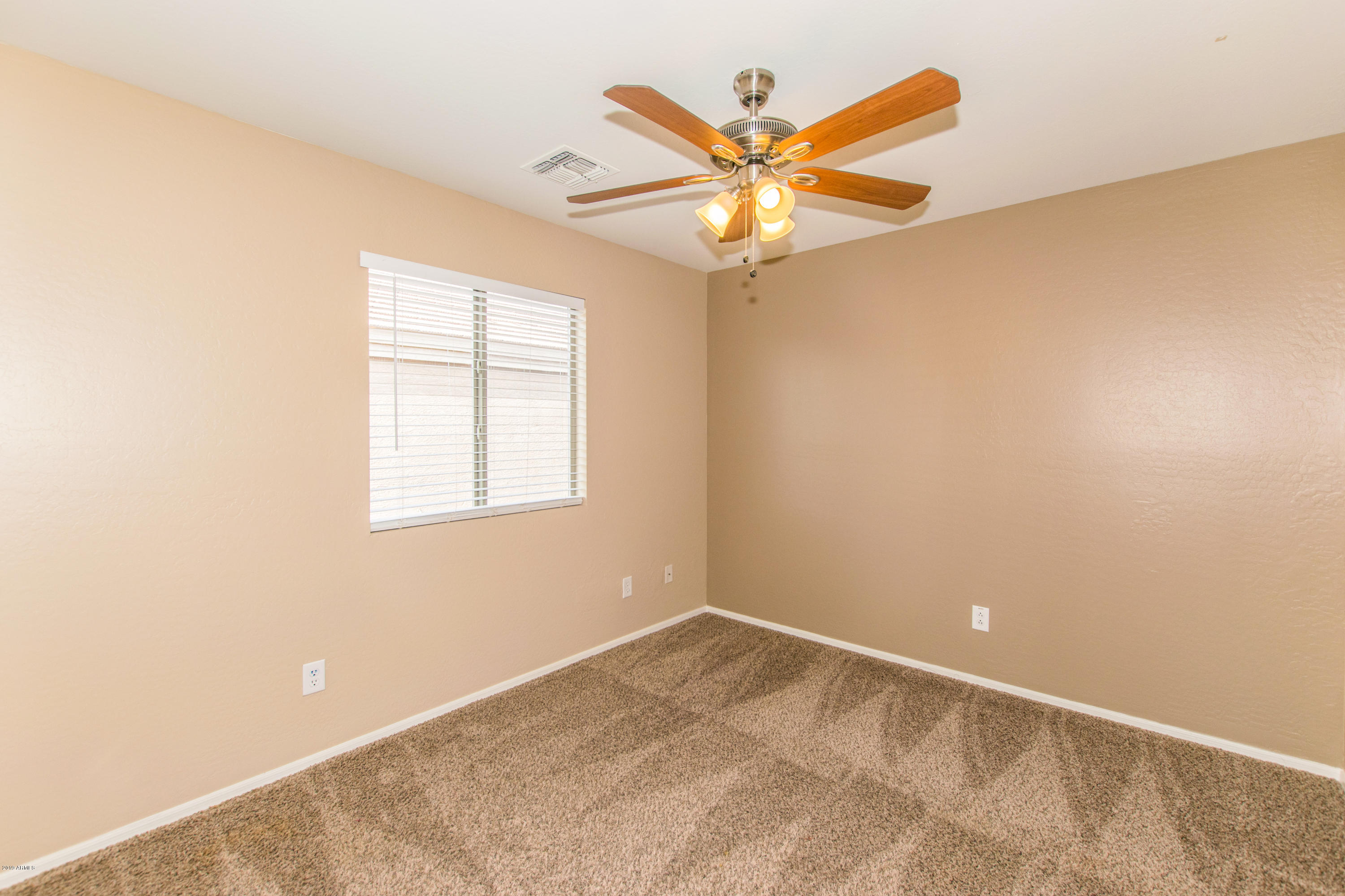 43750 West Magnolia Road Maricopa, AZ 85138 - Photo 19 of 28 an empty room with window and a fan