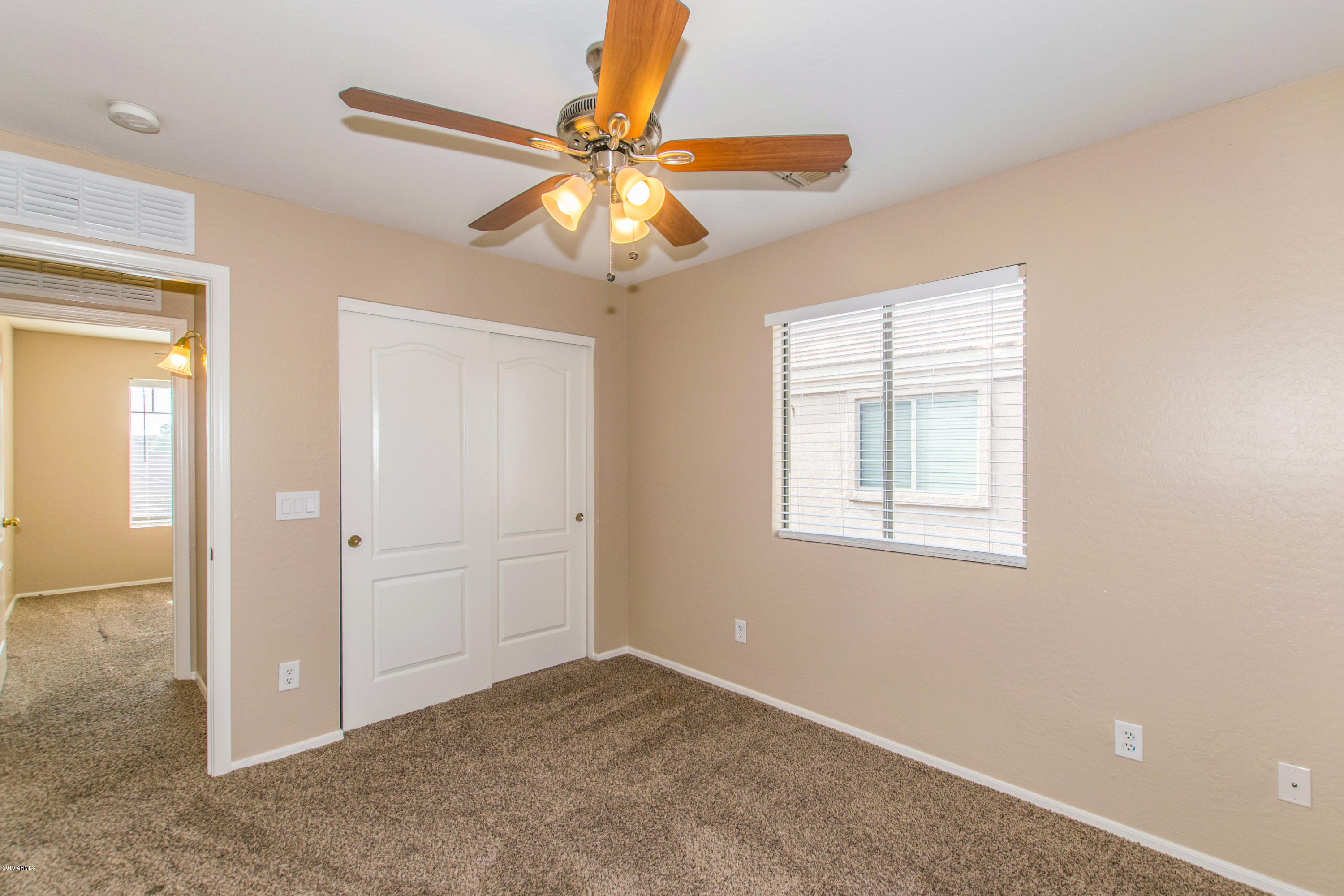 43750 West Magnolia Road Maricopa, AZ 85138 - Photo 20 of 28 an empty room with windows and fan