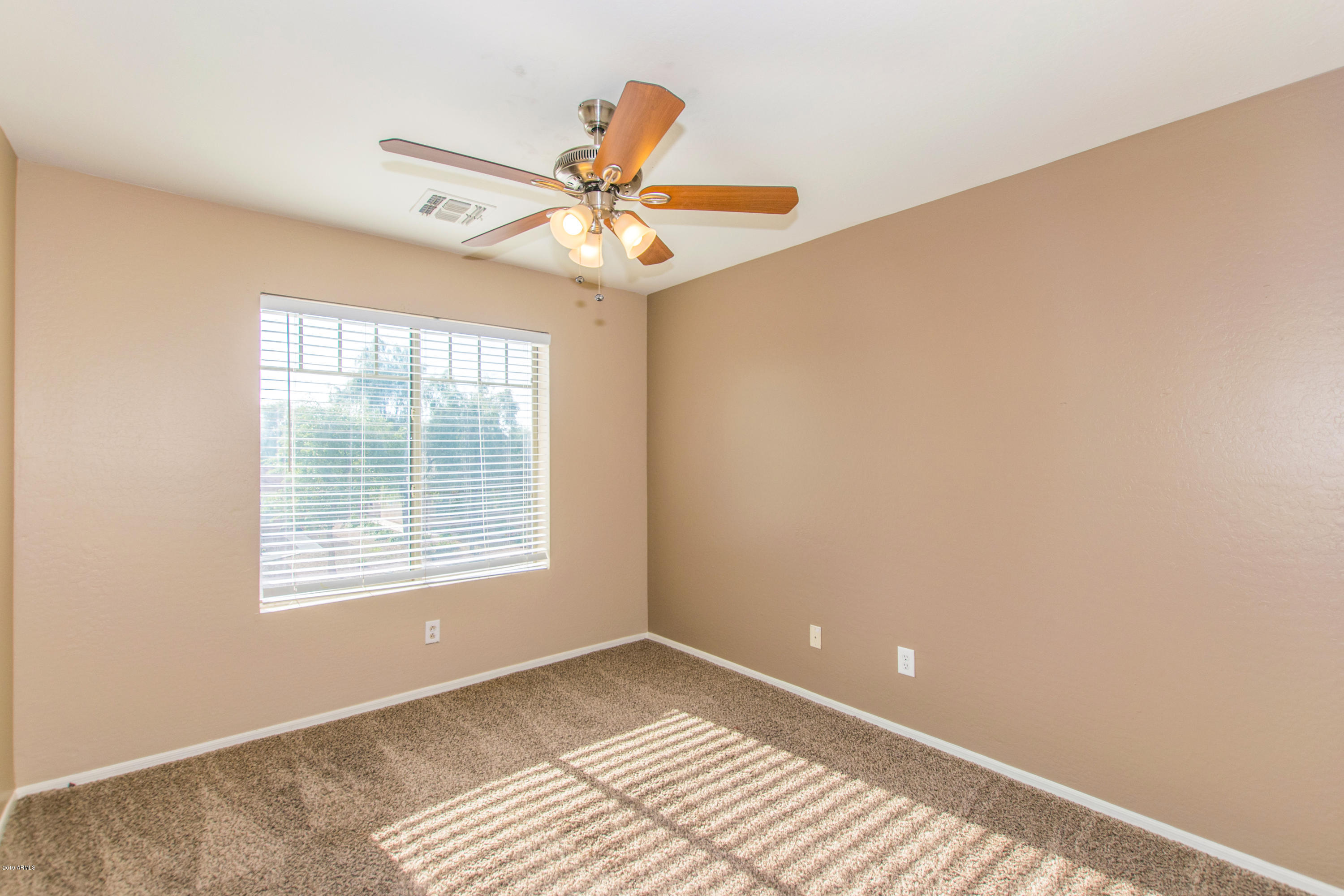 43750 West Magnolia Road Maricopa, AZ 85138 - Photo 21 of 28 a view of an empty room with a window