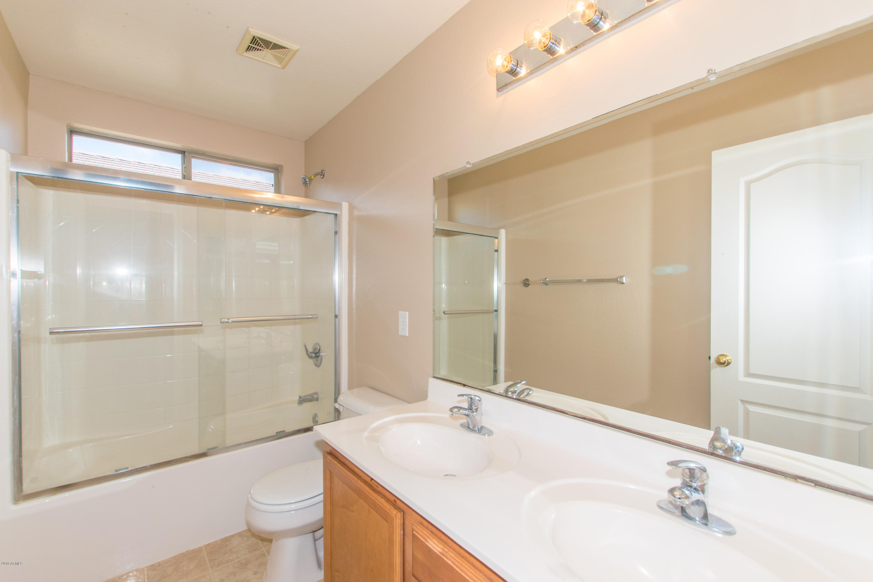 43750 West Magnolia Road Maricopa, AZ 85138 - Photo 23 of 28 a bathroom with a granite countertop sink toilet and shower