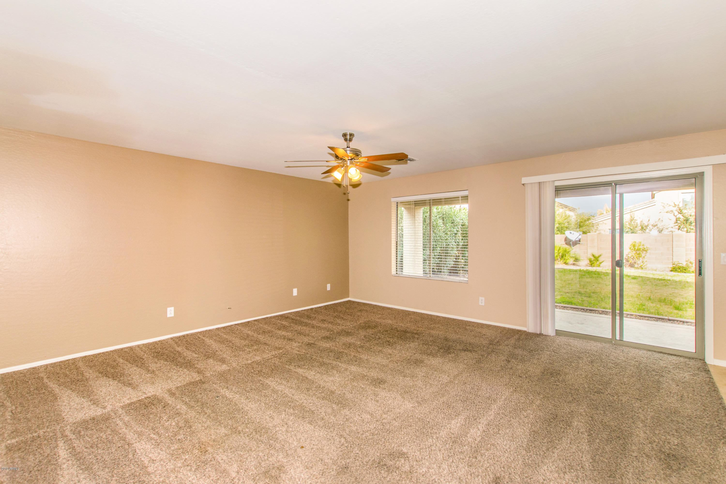 43750 West Magnolia Road Maricopa, AZ 85138 - Photo 3 of 28 a view of a livingroom with a ceiling fan and window
