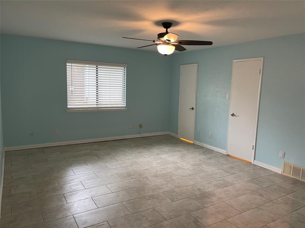 3732 Pinewood Street Bedford, TX 76021 - Photo 11 of 18 a view of an empty room with a chandelier fan