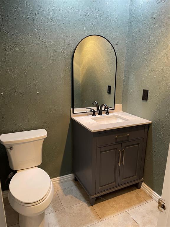 3732 Pinewood Street Bedford, TX 76021 - Photo 12 of 18 a bathroom with a toilet sink and mirror