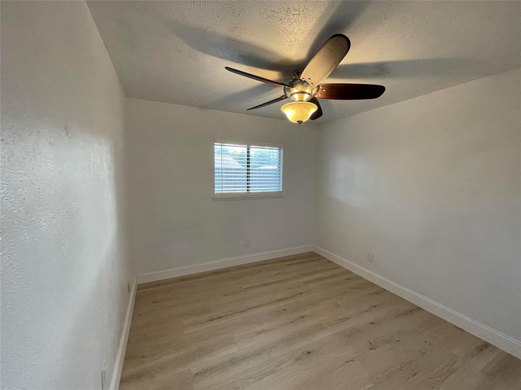 3732 Pinewood Street Bedford, TX 76021 - Photo 15 of 18 an empty room with windows and a ceiling fan