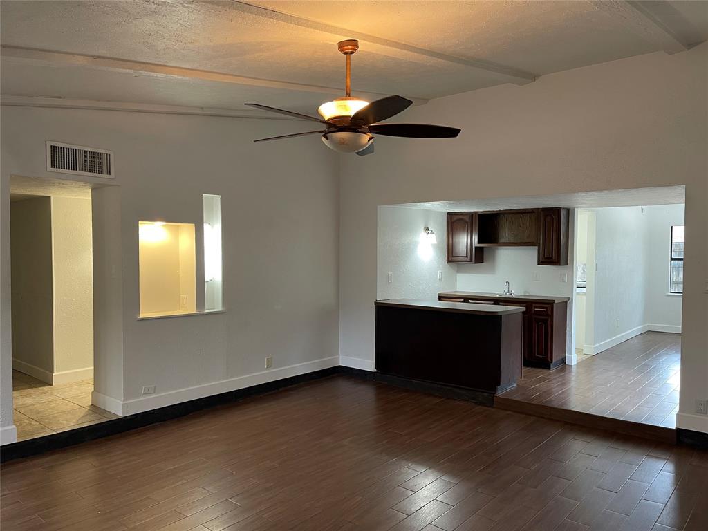 3732 Pinewood Street Bedford, TX 76021 - Photo 4 of 18 a view of an empty room with wooden floor and a fireplace