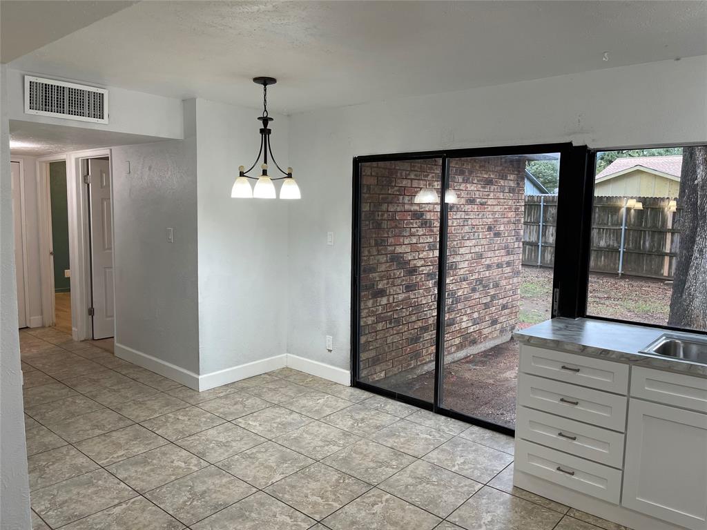 3732 Pinewood Street Bedford, TX 76021 - Photo 9 of 18 a view of a hallway with windows