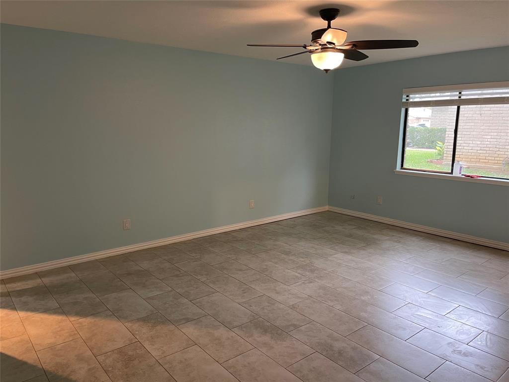 3732 Pinewood Street Bedford, TX 76021 - Photo 10 of 18 an empty room with windows and fan