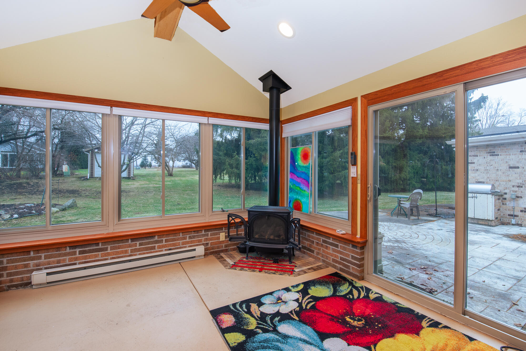 4024 South Brook Road Caledonia, WI 53126 - Photo 9 of 66 Gas stove and electric baseboard heating in with an abundance of windows in the Four Season Room