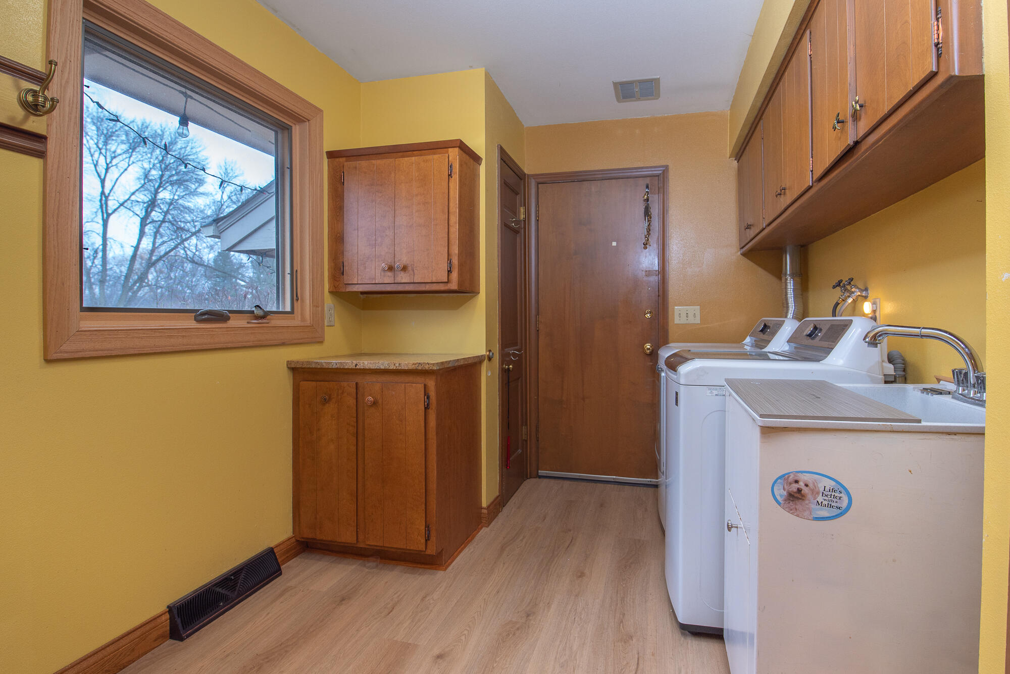 4024 South Brook Road Caledonia, WI 53126 - Photo 32 of 66 Main floor laundry room with washer, dryer and utility sink with cabinets and granite counter top