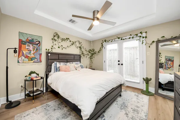 a bedroom with a bed and a chandelier