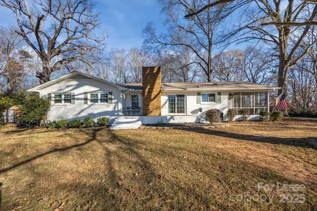 a front view of a house with a yard and lake view