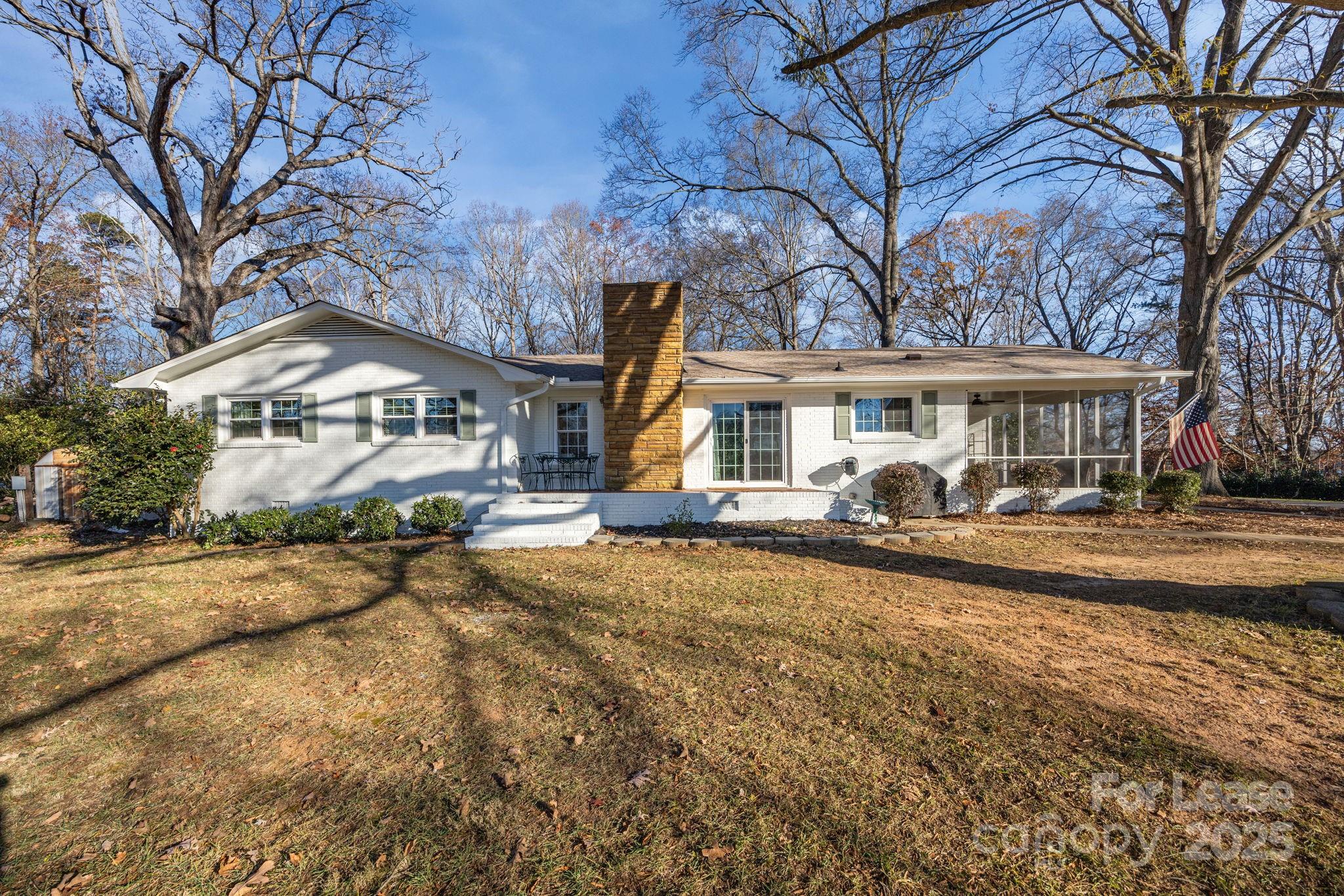 a front view of a house with a yard and lake view