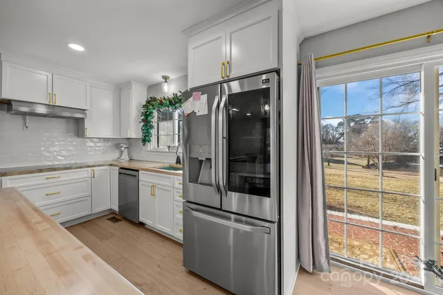 a kitchen with a refrigerator and a sink