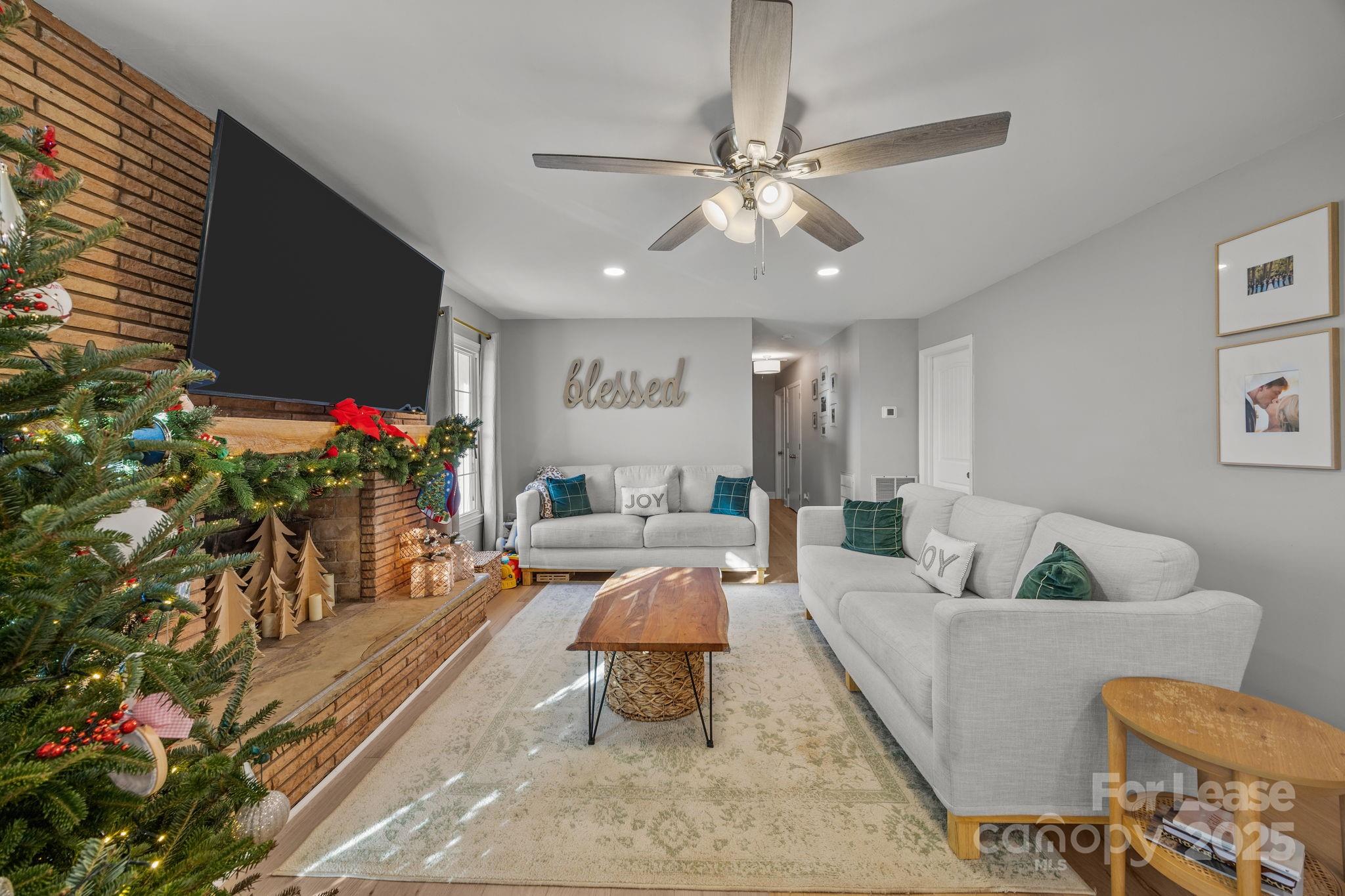 4611 Kiser Island Road Terrell, NC 28682 - Photo 22 of 40 a living room with furniture and a chandelier