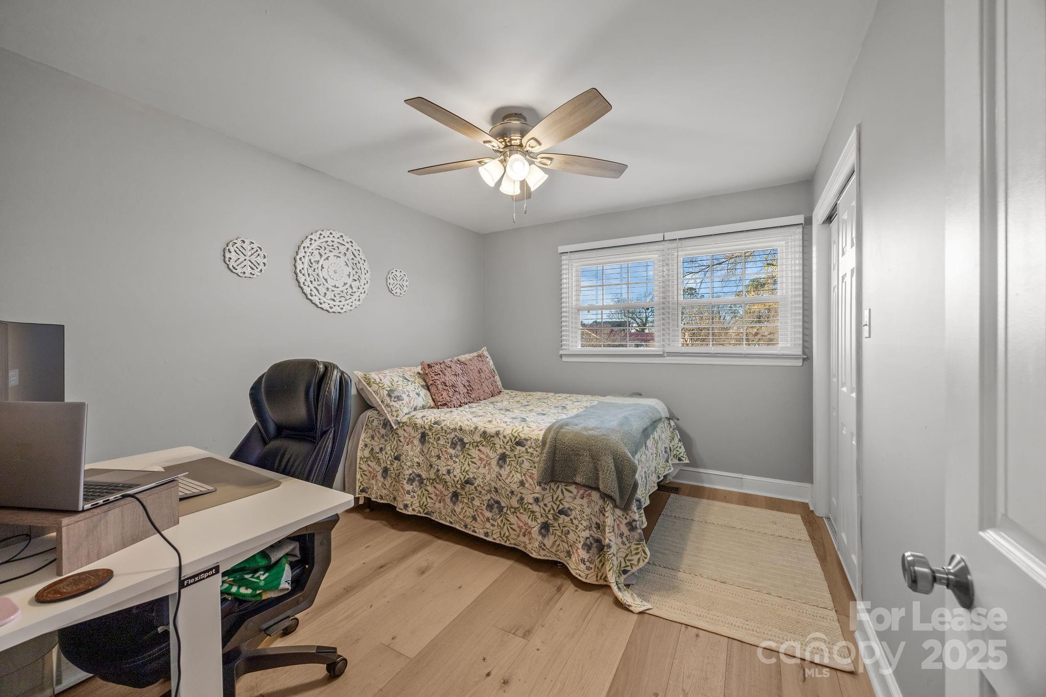 4611 Kiser Island Road Terrell, NC 28682 - Photo 24 of 40 a bedroom with a bed and a chandelier