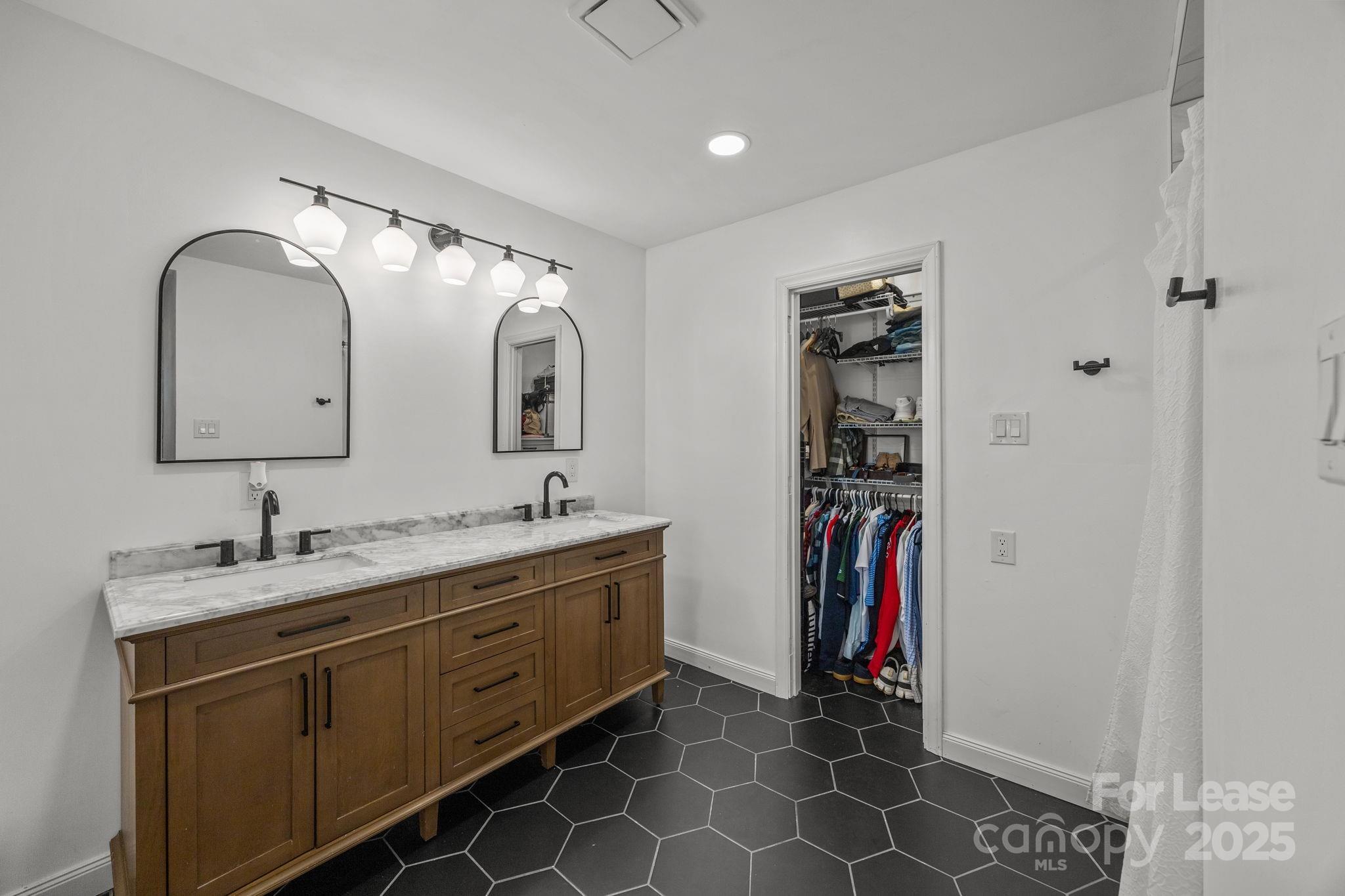 4611 Kiser Island Road Terrell, NC 28682 - Photo 28 of 40 a bathroom with a double vanity sink and a mirror