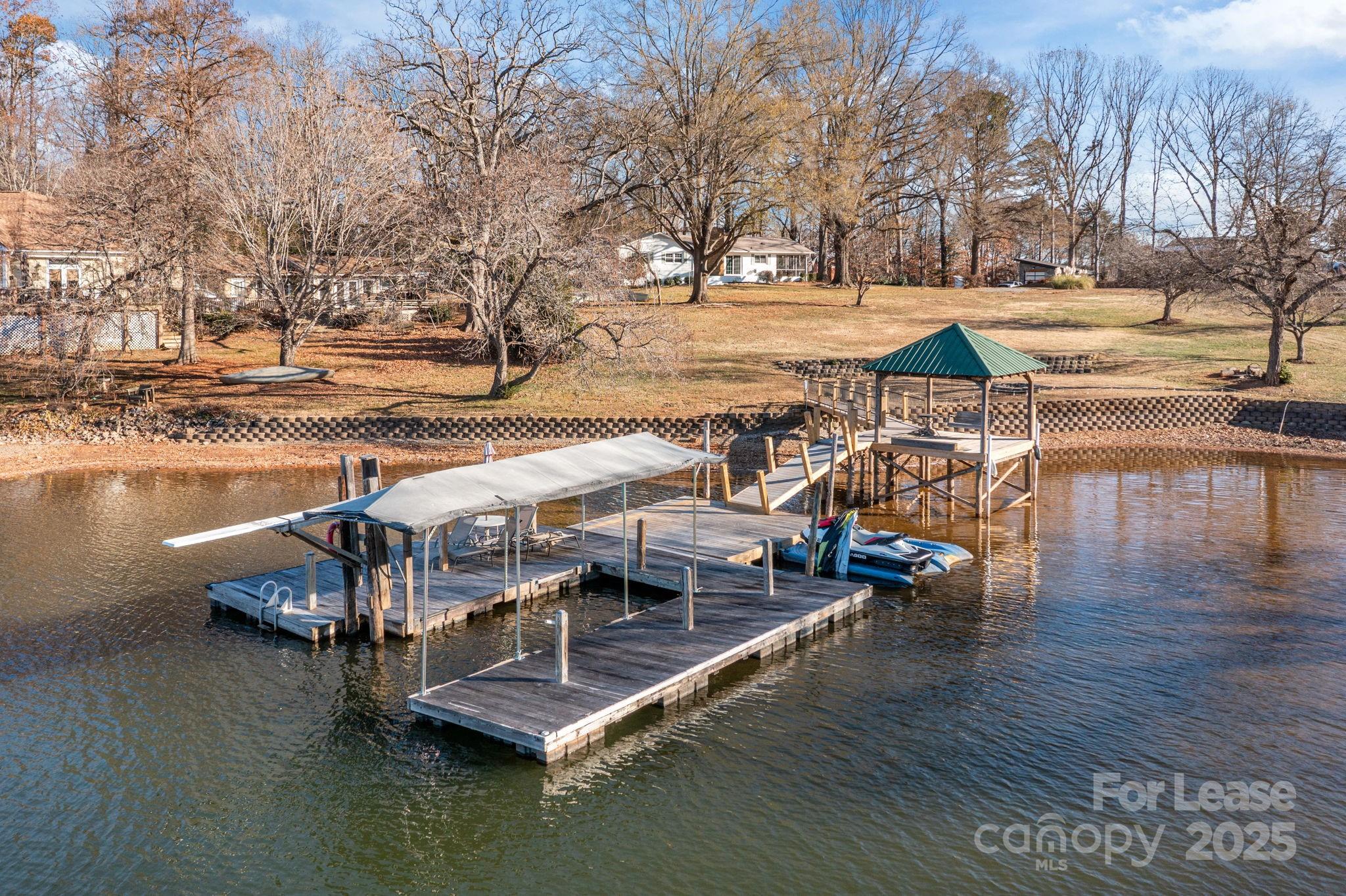 4611 Kiser Island Road Terrell, NC 28682 - Photo 30 of 40 a view of a lake with lawn chairs and wooden bench