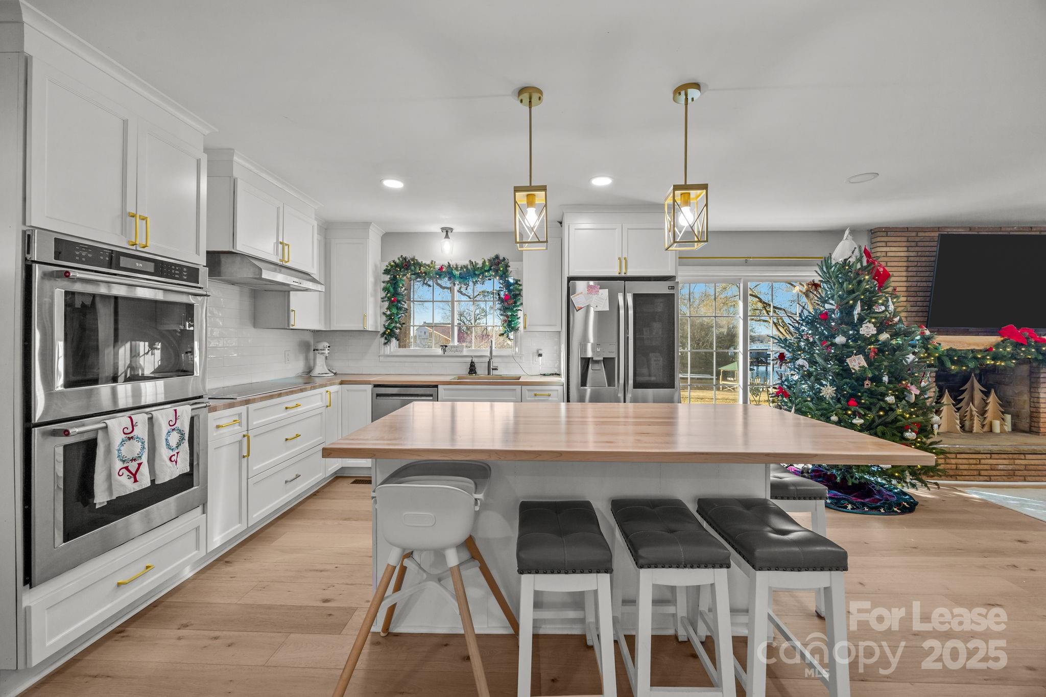4611 Kiser Island Road Terrell, NC 28682 - Photo 8 of 40 a kitchen with stainless steel appliances granite countertop a stove a sink and a refrigerator