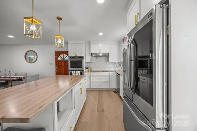 a kitchen with cabinets and stainless steel appliances