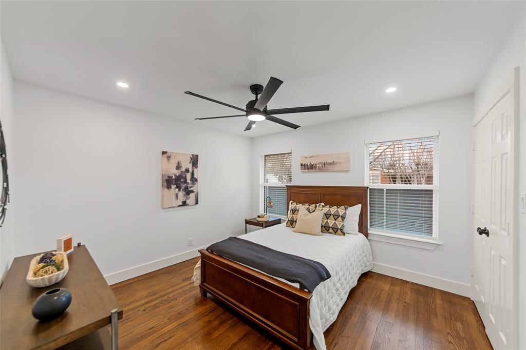 2945 Healey Drive Dallas, TX 75228 - Photo 19 of 38 a bedroom with a bed and wooden floor