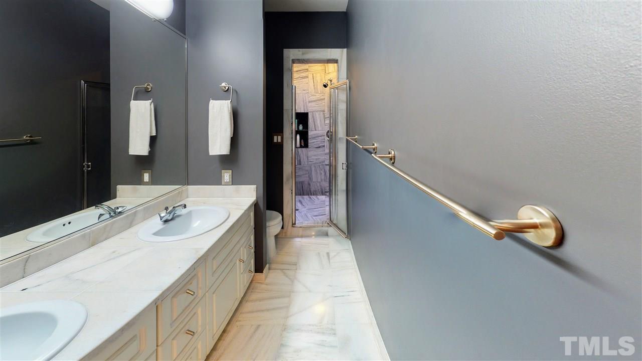 4212 Windsor Place Raleigh, NC 27609 - Photo 12 of 30 a hallway with a sink and mirror