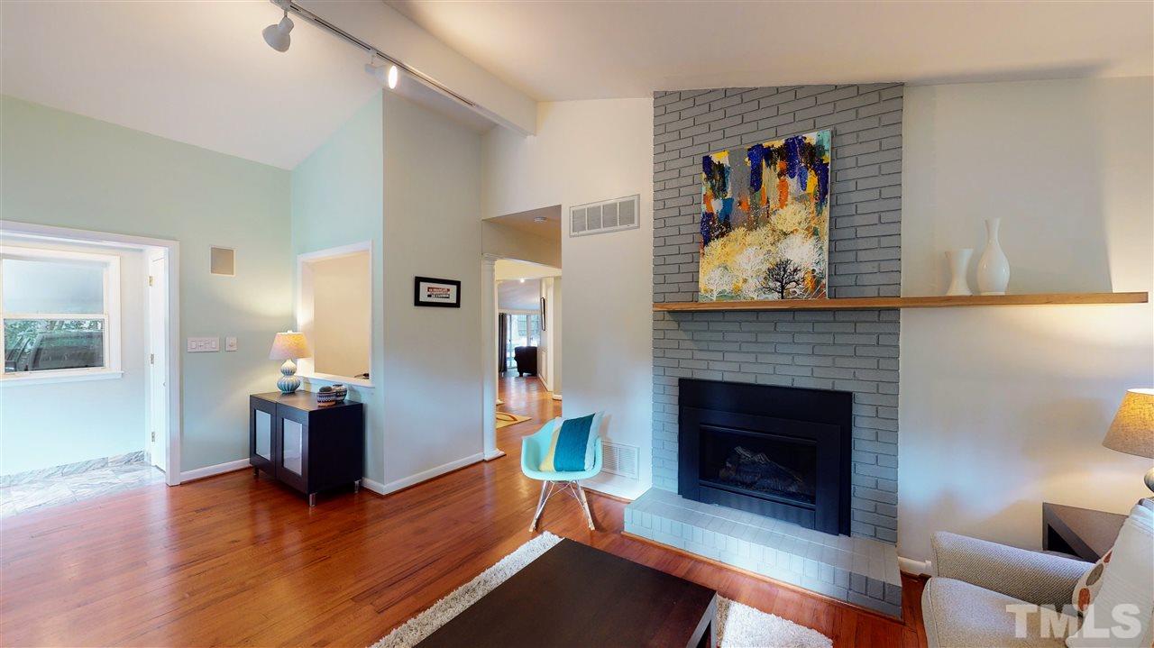 4212 Windsor Place Raleigh, NC 27609 - Photo 13 of 30 a living room with furniture and a fireplace